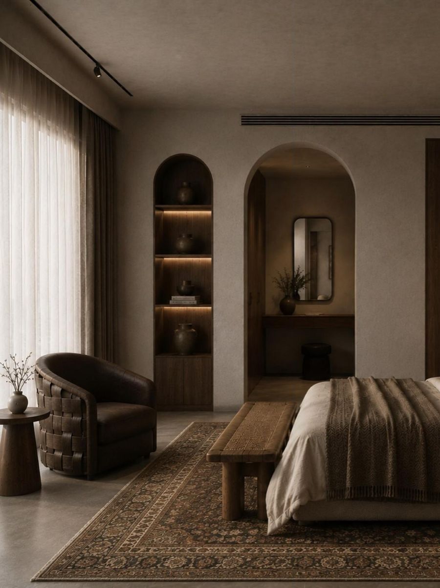 Reading corner with a woven leather armchair and an arched niche with lit shelves